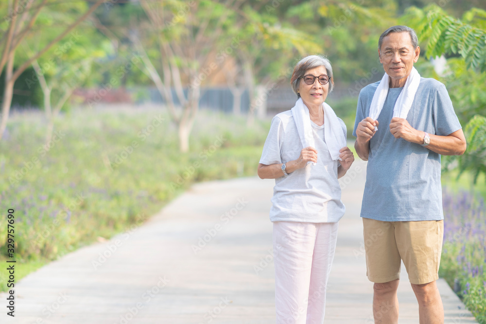 Asian senior retired couple jogging or exercise in the park. Healthy elderly people concept Asian senior retired couple jogging or exercise in the park. Healthy elderly people concept