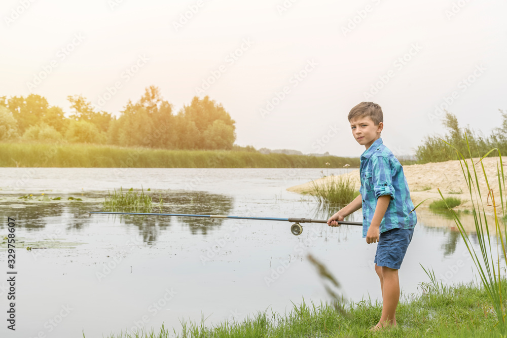 Little boy is fishing on the river Little boy is fishing on the river