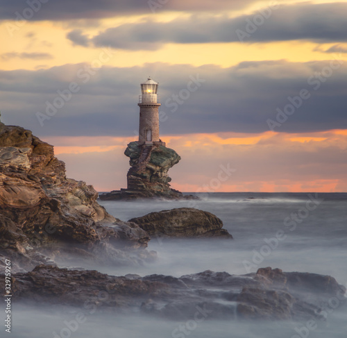 Bild auf Leinwand Lighthouse in Andros island (chora) Greece