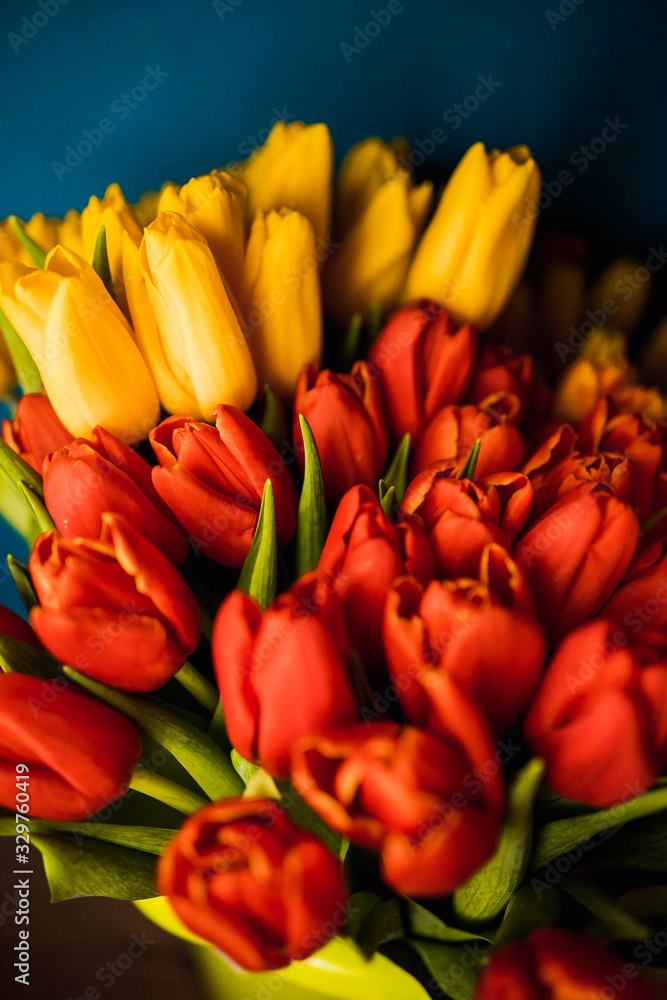 tied yellow and red tulips on wooden surface tied yellow and red tulips on wooden surface