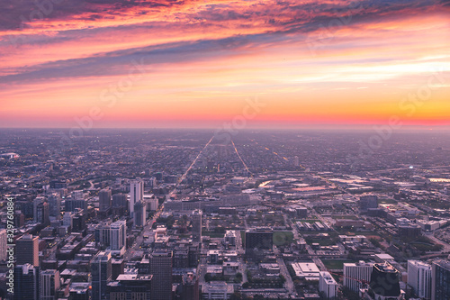 Panoramic view of Chicago city from downtown during a vibrant sunset with roads and building lights 