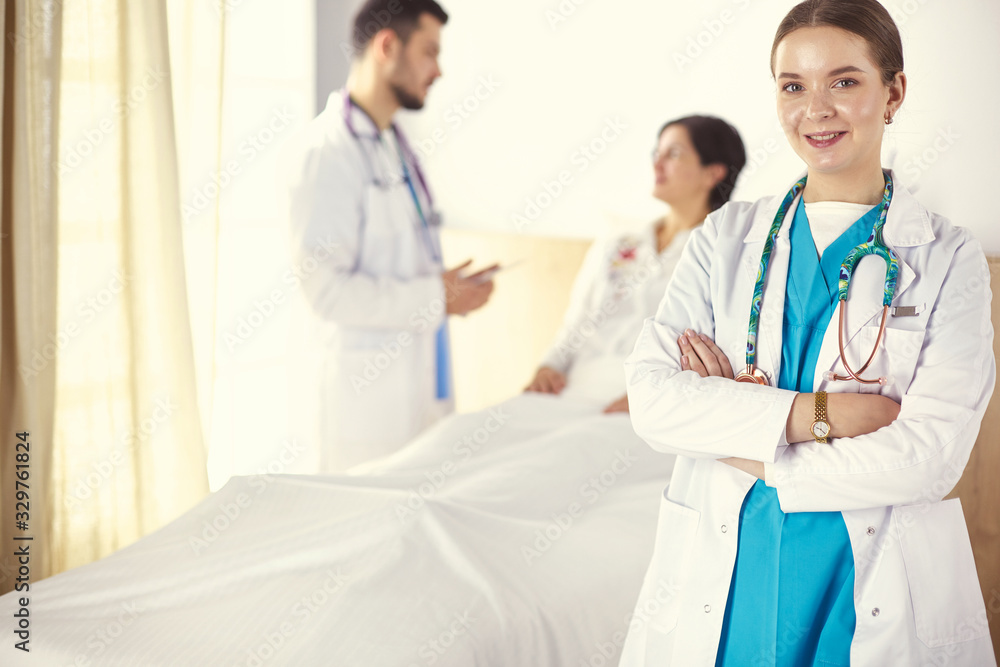 Doctors and nurses stacking hands. Isolated on white Doctors and nurses stacking hands. Isolated on white
