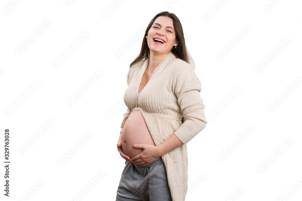 Positive future mom laughing while holding her tummy Positive future mom laughing while holding her tummy