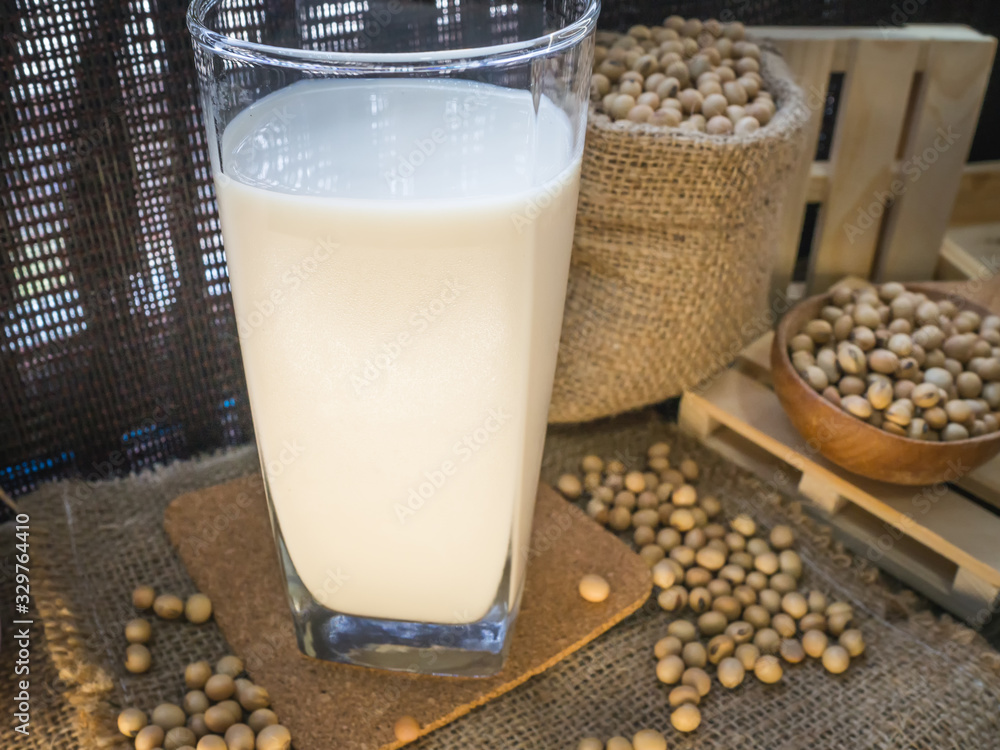 Soya beans and soya milk glass. Placed on a table with sacks. Soya beans and soya milk glass. Placed on a table with sacks.