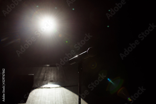 Close up of microphone on stage in black background