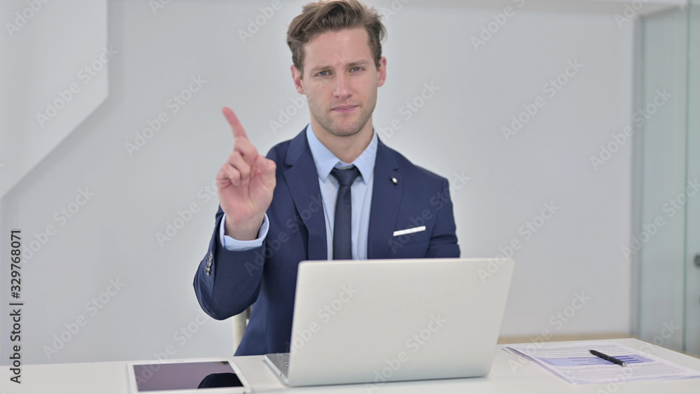 Young Businessman saying No by Finger in Office Young Businessman saying No by Finger in Office