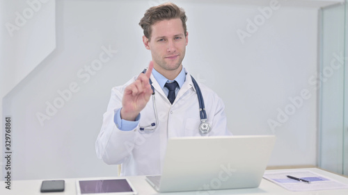 Young Doctor saying No with Finger Sign in Clinic