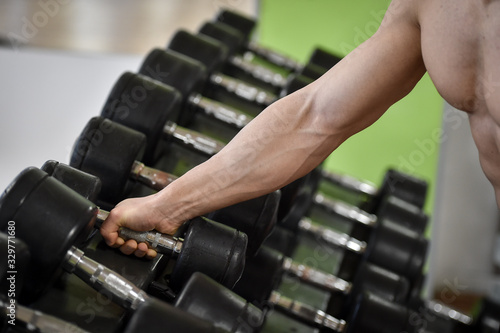 Man working out strength exercises in a fitness gym