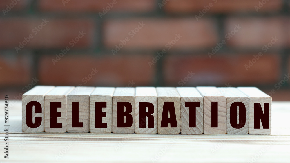 concept word celebration on cubes against the background of a brick wall