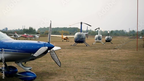 Helicopters and planes aircraft moving on the airfield. Aviation festival holiday at the aerodrome airport  photo