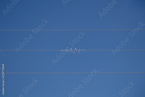 Coiled wire on power cables serving as a humane bird scarer in Andalucia Spain