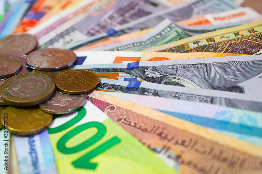 Banknotes and coins from around the world laid out in a circle Banknotes and coins from around the world laid out in a circle