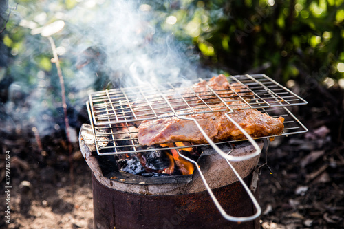 grill pork on iron net barbecue outdoor park