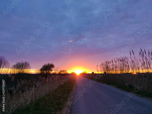 Sunset behind a country road