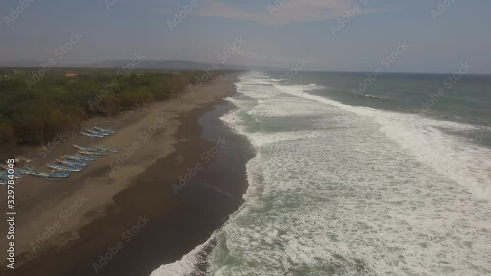 Aerial view seascape ocean waves surf. sandy beach near ocean with big waves in tropical resort, Yogyakarta, Indonesia. seascape, ocean and beautiful beach. Travel concept. Indonesia, java Aerial view seascape ocean waves surf. sandy beach near ocean with big waves in tropical resort, Yogyakarta, Indonesia. seascape, ocean and beautiful beach. Travel concept. Indonesia, java