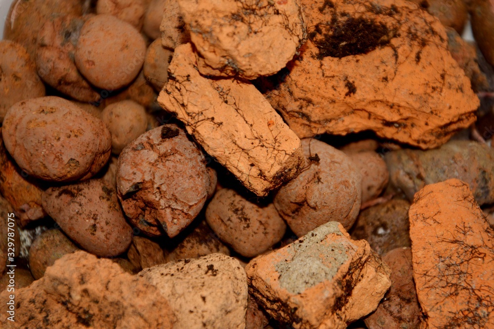 Decorative stones, drainage for plants, pebbles, expanded clay, brown stones of different shapes Decorative stones, drainage for plants, pebbles, expanded clay, brown stones of different shapes