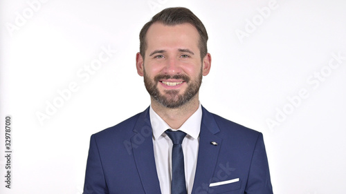 Portrait of Young Businessman Saying Yes by Head Shake, White Background