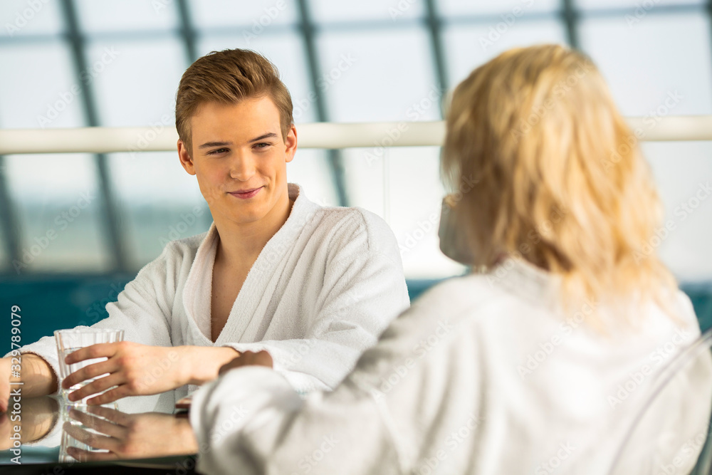 girl and guy talking on vacation in bathrobes girl and guy talking on vacation in bathrobes