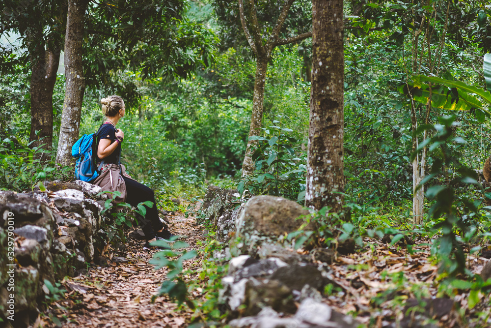 Female traveler rest during hike in coffee plantation on Santo Antao Cape Verde Female traveler rest during hike in coffee plantation on Santo Antao Cape Verde