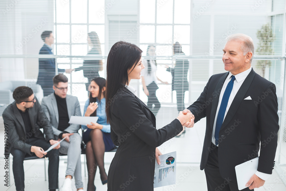 boss and the assistant discuss a business document. boss and the assistant discuss a business document.