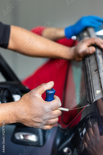 Wallpaper Mural Car repair service, Afro American man working on glass replacement. Windshield insurance, safety and driving concept. Automotive industry. Torontodigital.ca