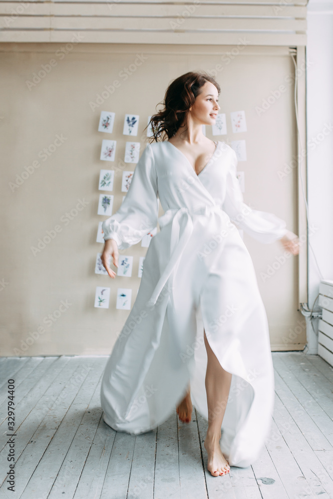 Wedding printing on the background. Portrait of the bride faynart. Morning of the bride in a boudoir dress. Bright interior of the Studio with postcards. Wedding printing on the background. Portrait of the bride faynart. Morning of the bride in a boudoir dress. Bright interior of the Studio with postcards.