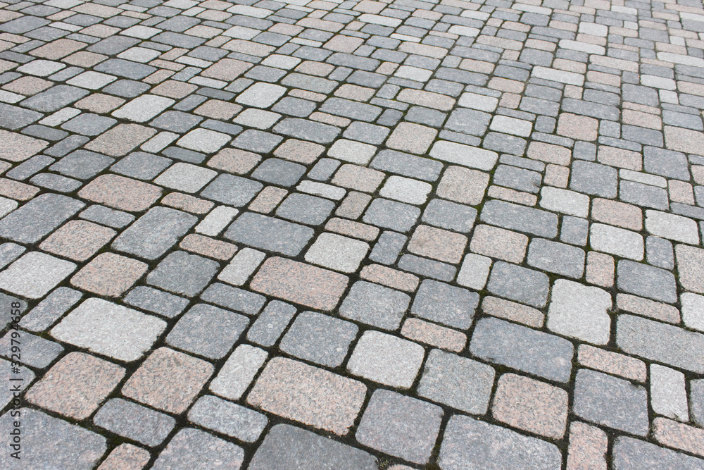 Texture of pathway pavement covered with rock bricks.