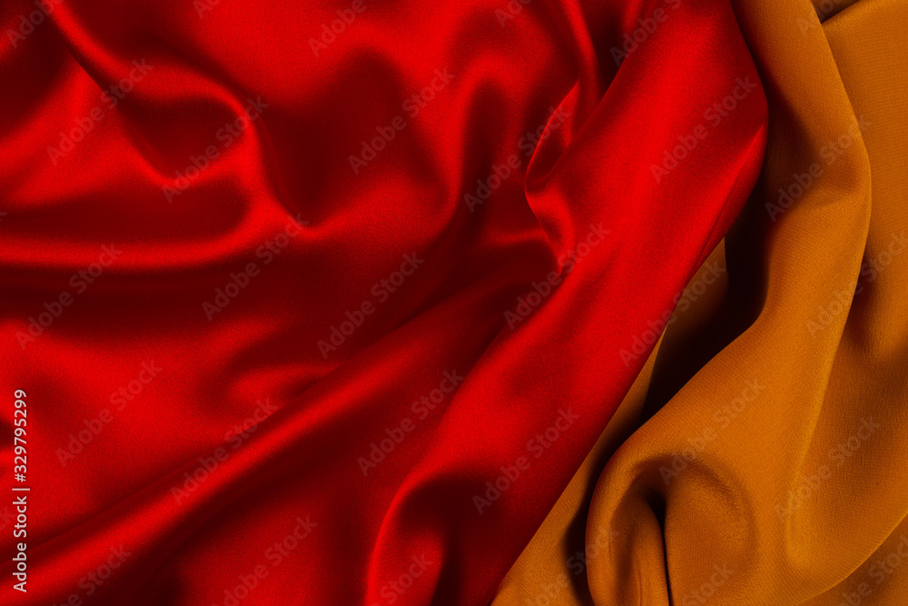 Red and orange silk or satin luxury fabric texture can use as abstract background. Red and orange silk or satin luxury fabric texture can use as abstract background.