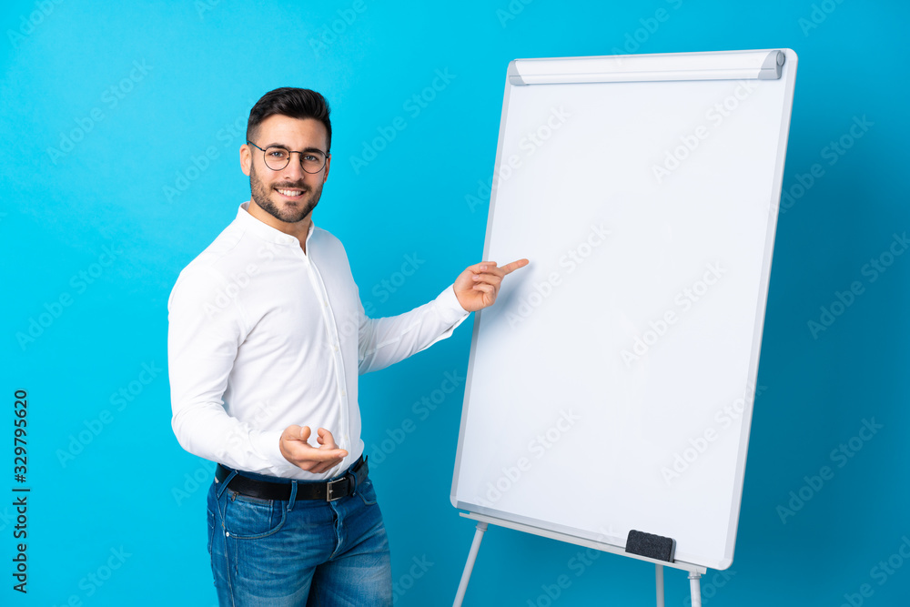 Businessman giving a presentation on white board giving a presentation on white board Businessman giving a presentation on white board giving a presentation on white board