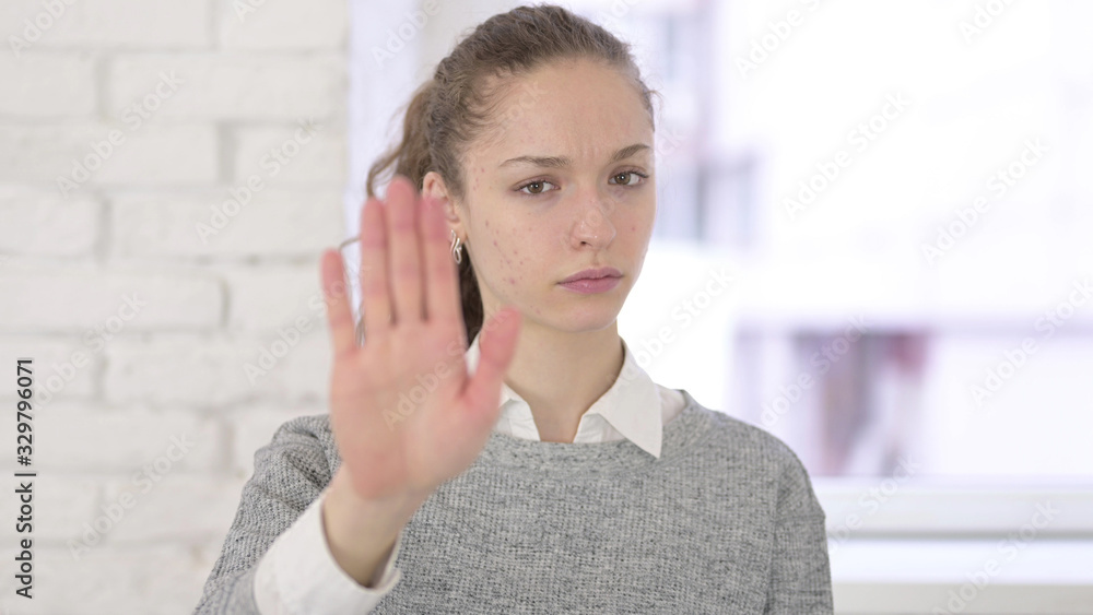 Portrait of Serious Young Latin Woman showing Stop Sign with Hands Portrait of Serious Young Latin Woman showing Stop Sign with Hands