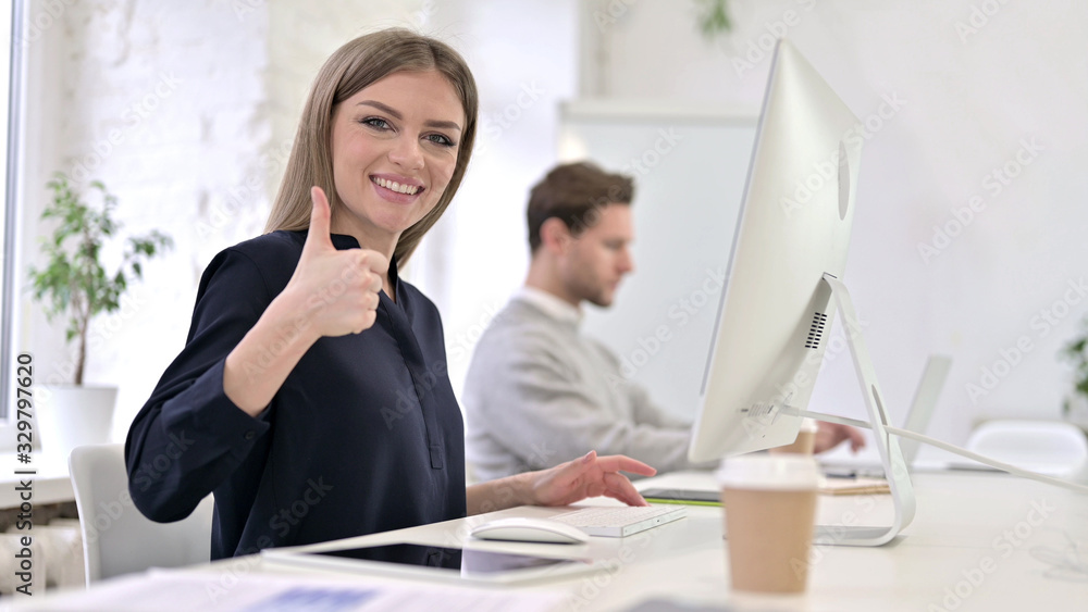 Ambitious Creative Woman showing Thumbs Up in Office Ambitious Creative Woman showing Thumbs Up in Office