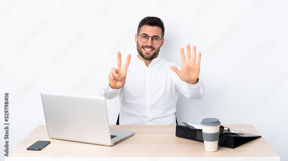 Young businessman in a workplace counting seven with fingers Young businessman in a workplace counting seven with fingers