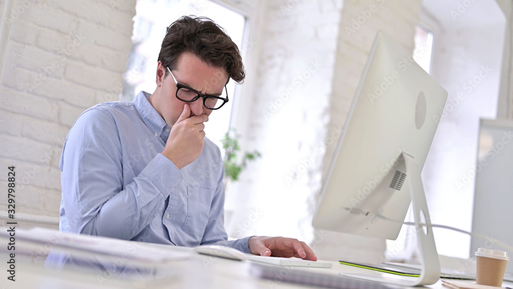 Sick Working Young Man Coughing in Modern Office