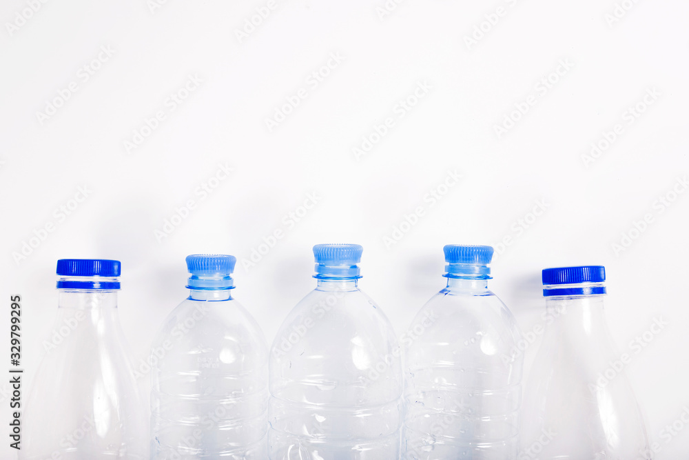 Empty plastic bottle with a blue cap on a white background Empty plastic bottle with a blue cap on a white background