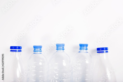 Empty plastic bottle with a blue cap on a white background
