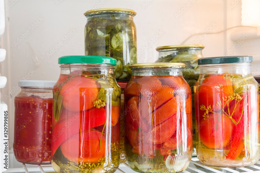 Canned vegetables in glass jars in the refrigerator. Home cooking and preservation