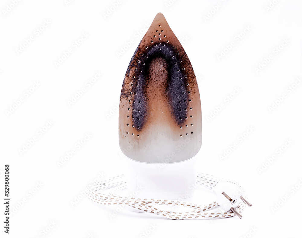 Fototapeta premium Iron with a dirty and burnt surface on a white background