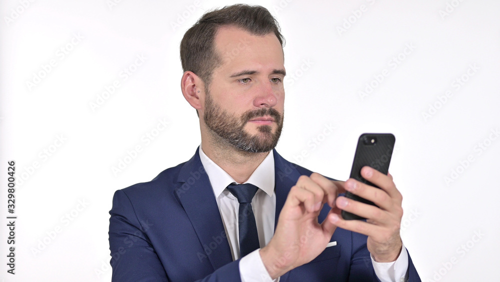Portrait of Cheerful Young Businessman using Smartphone, White Background Portrait of Cheerful Young Businessman using Smartphone, White Background