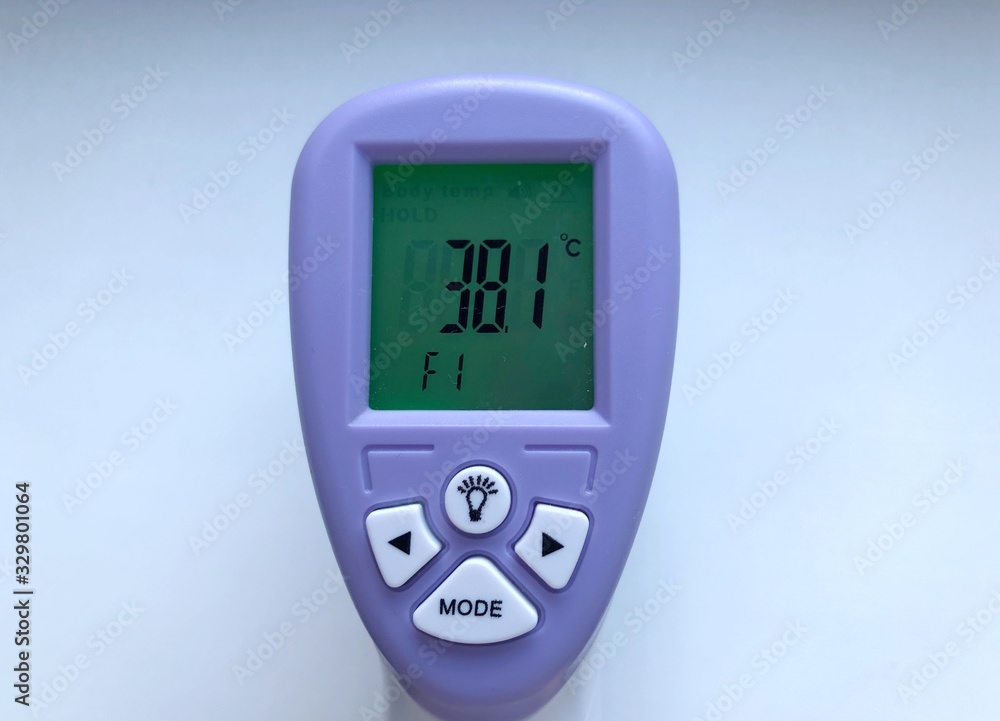 Electronic thermometer in hand. Is used to measure a patient's temperature Electronic thermometer in hand. Is used to measure a patient's temperature