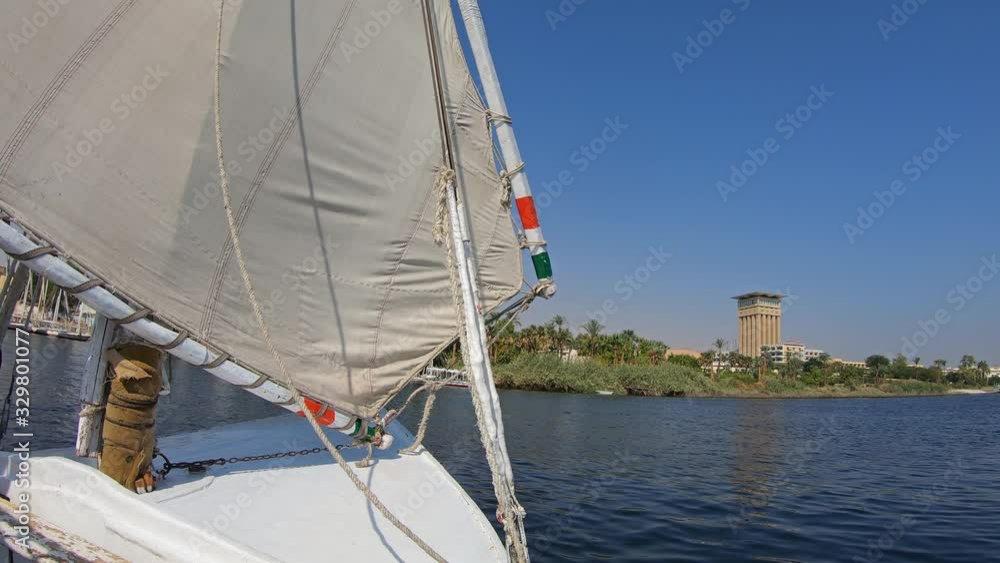 View from an Egyptian felucca boat sailing along the Nile River in Aswan, 4k View from an Egyptian felucca boat sailing along the Nile River in Aswan, 4k