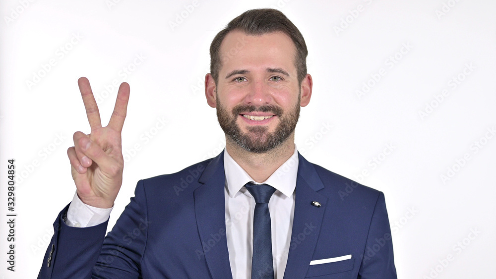 Portrait of Successful Young Businessman showing Victory Sign, White Background Portrait of Successful Young Businessman showing Victory Sign, White Background