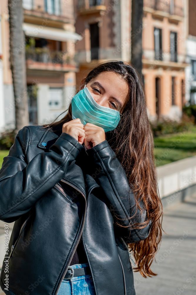 Fototapeta premium Girl with a mask to protect walking on the street