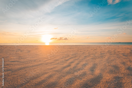 Sand and beach with sunset, peaceful sandy beach, sun beams. Calmness and relaxation tropical nature pattern