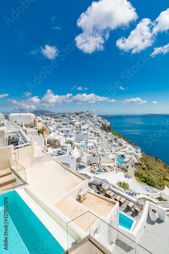 Santorini, Greece. Famous view of traditional white architecture Santorini landscape with blur sea in foreground. Summer vacations background. Luxury travel tourism concept. Amazing summer destination