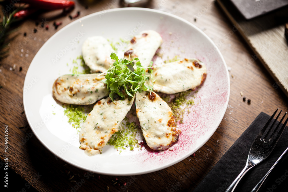 Cooked green mussels with parmegano and cream cheese