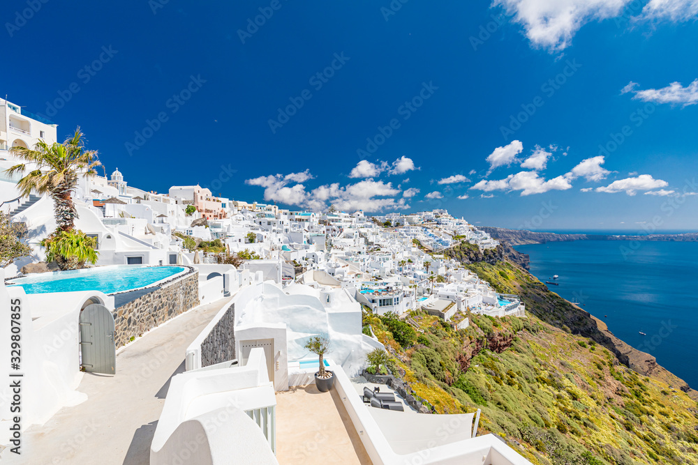 Luxury summer travel and vacation landscape. White architecture on Santorini island, Greece. Swimming pool in luxury hotel. Beautiful view on the sea