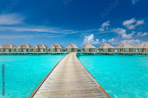 Panoramic landscape of Maldives beach. Tropical panorama, luxury water villa resort with wooden pier or jetty. Luxury travel destination background for summer holiday and vacation concept.