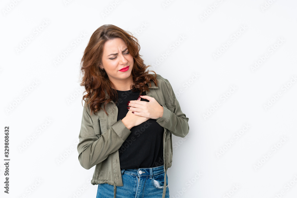 Young Russian woman over isolated white background having a pain in the heart