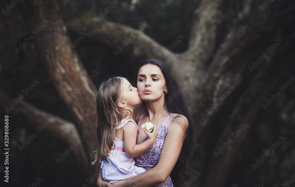happy mother holds her little daughter in her arms. happy mother holds her little daughter in her arms.