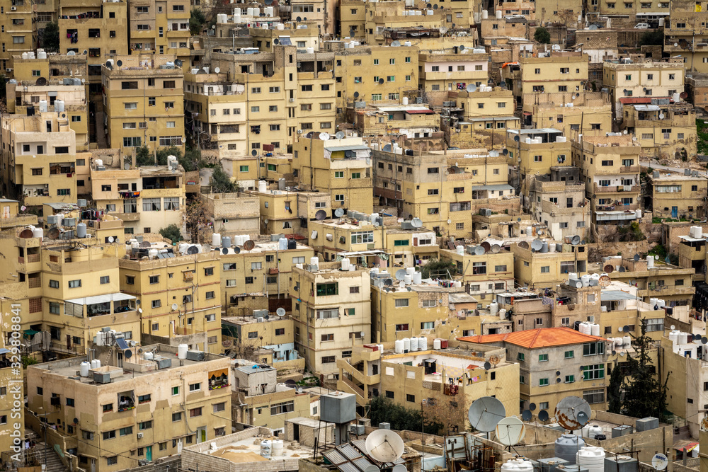 Very dense residential housing and building of middle eastern city of Amman, Jordan. Houses built up against a hill